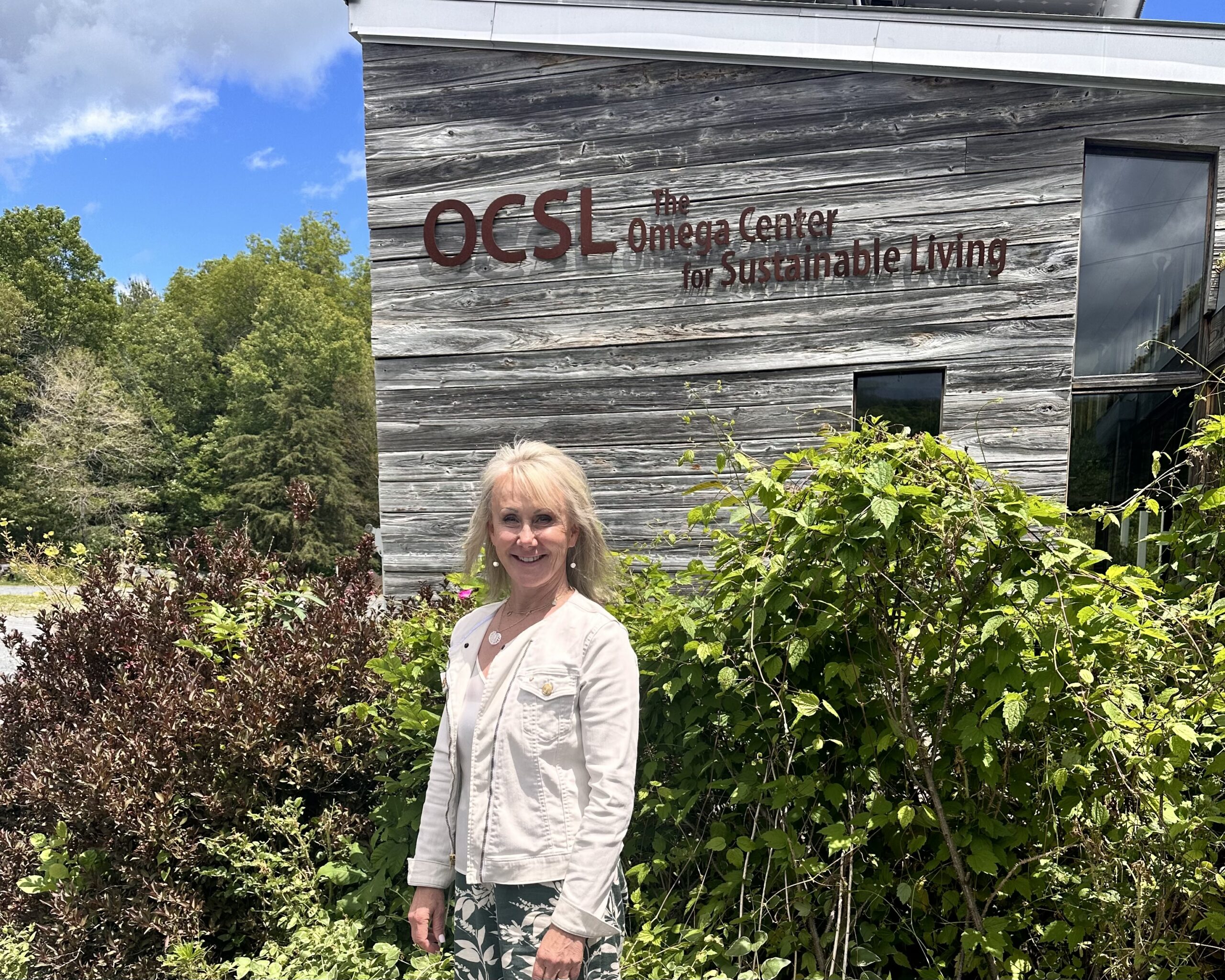 Cyndi in front of the OCSL Omega Center for Sustainable Living